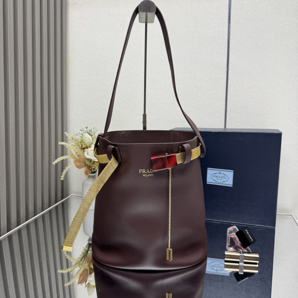 Pra*a buckle leather bucket bag with jeweled belt